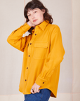 Front angled view of Flannel Overshirt in Mustard Yellow on Alex
