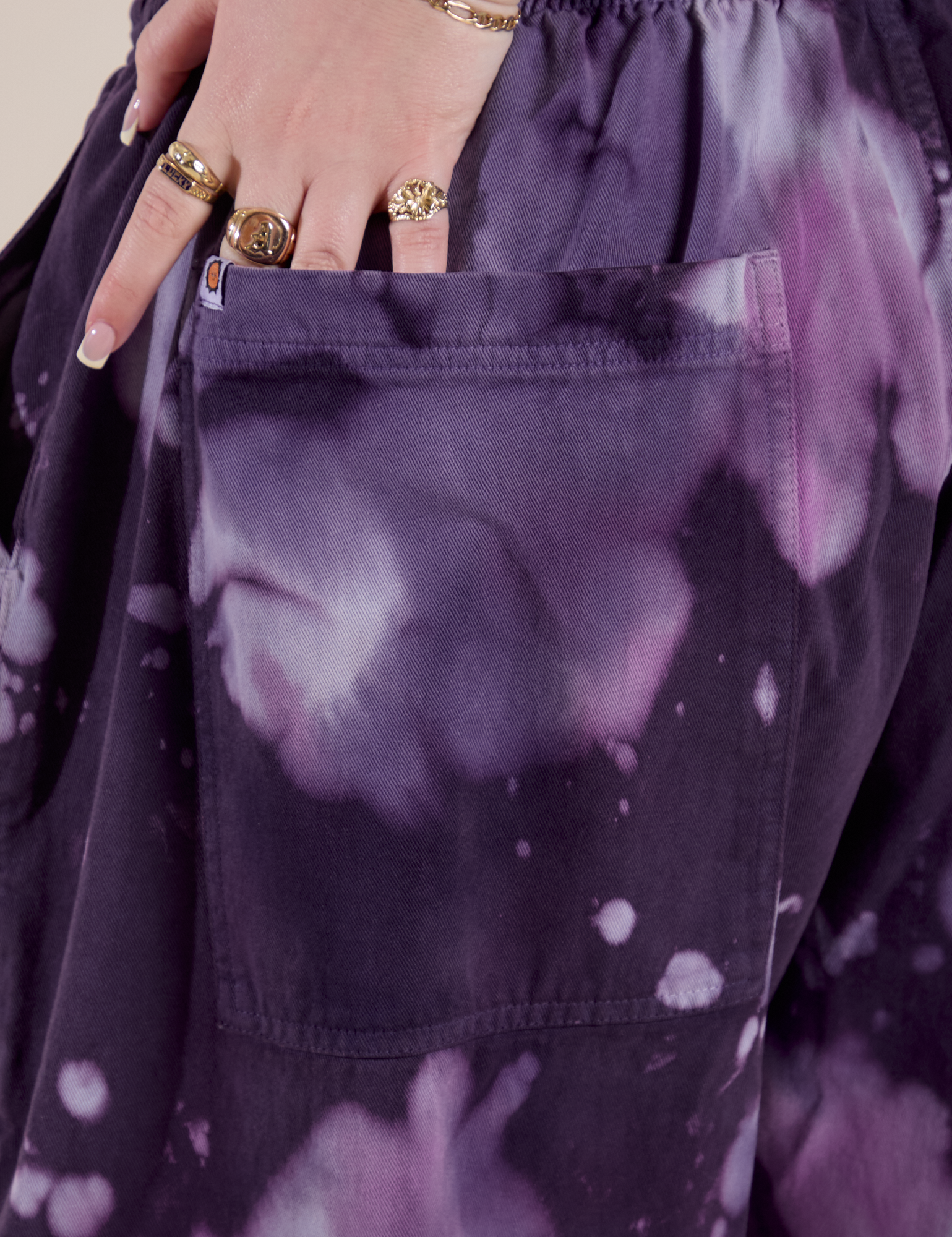 Close up of Sydney's hand in the back pocket of Magic Waters Drop Pocket Pants in Dark Lavender