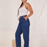 Side view of Denim Trouser Jeans in Dark Wash and vintage off-white Tank Top worn by Gabi