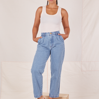 Gabi is 5'7" and wearing XXS Denim Trouser Jeans in Light Wash paired with vintage off-white Tank Top