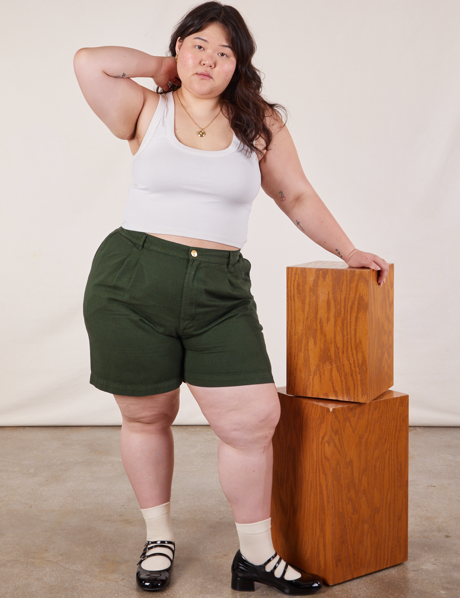 Ashley is wearing Trouser Shorts in Swamp Green and Cropped Tank in Vintage Tee Off-White