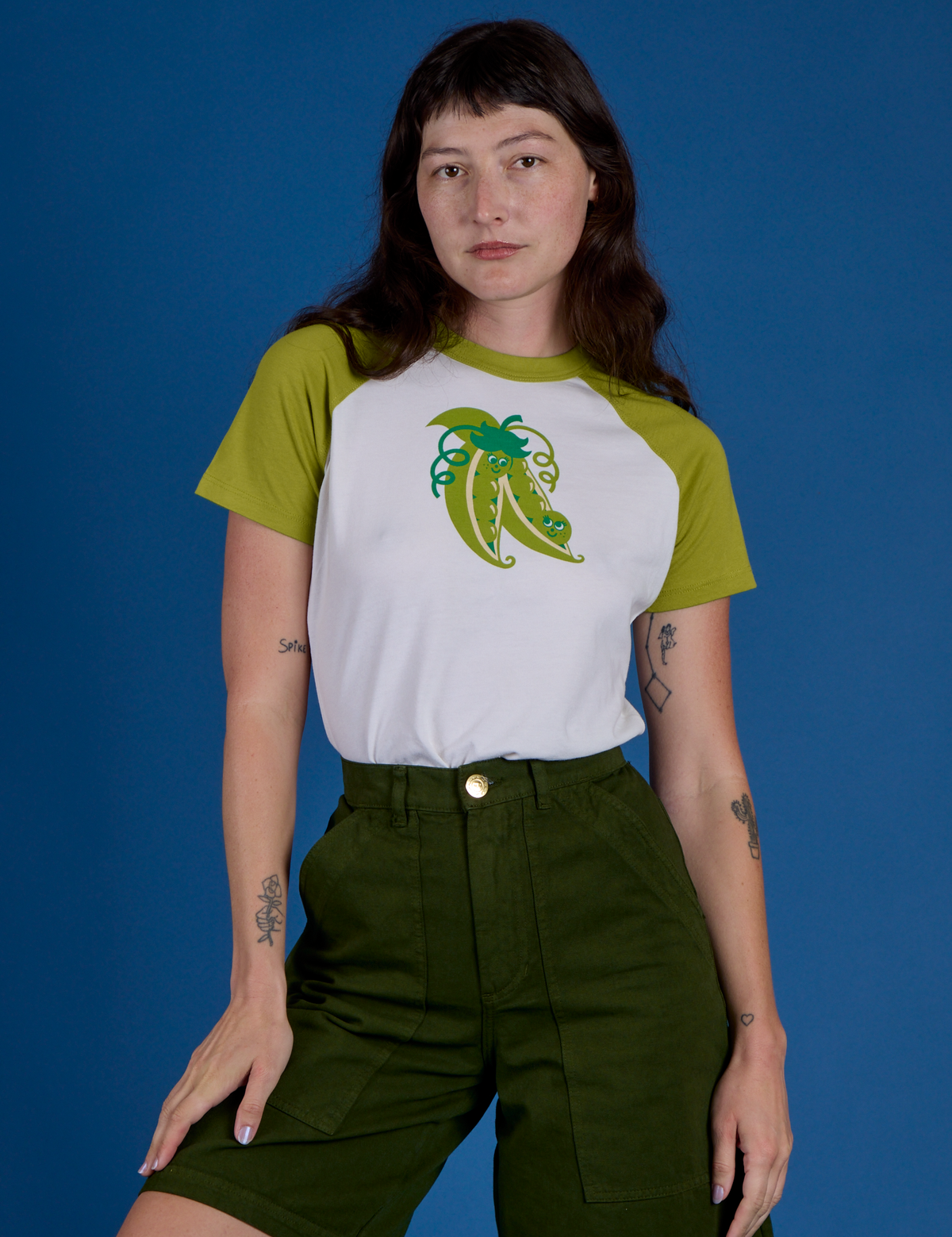 Alex is wearing Produce Raglan Tee in Snap Peas