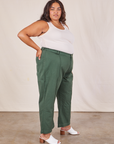 Side view of Western Pants in Dark Green Emerald and vintage off-white Tank Top worn by Alicia