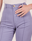 Front close up of Western Pants in Faded Grape worn by Alex. She has her thumb through one of the belt loops.