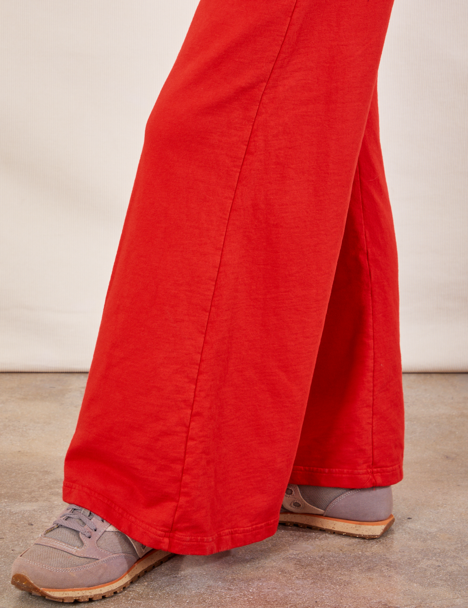 Wide Leg Sweat Pants in Mustang Red pant leg close up on Alex