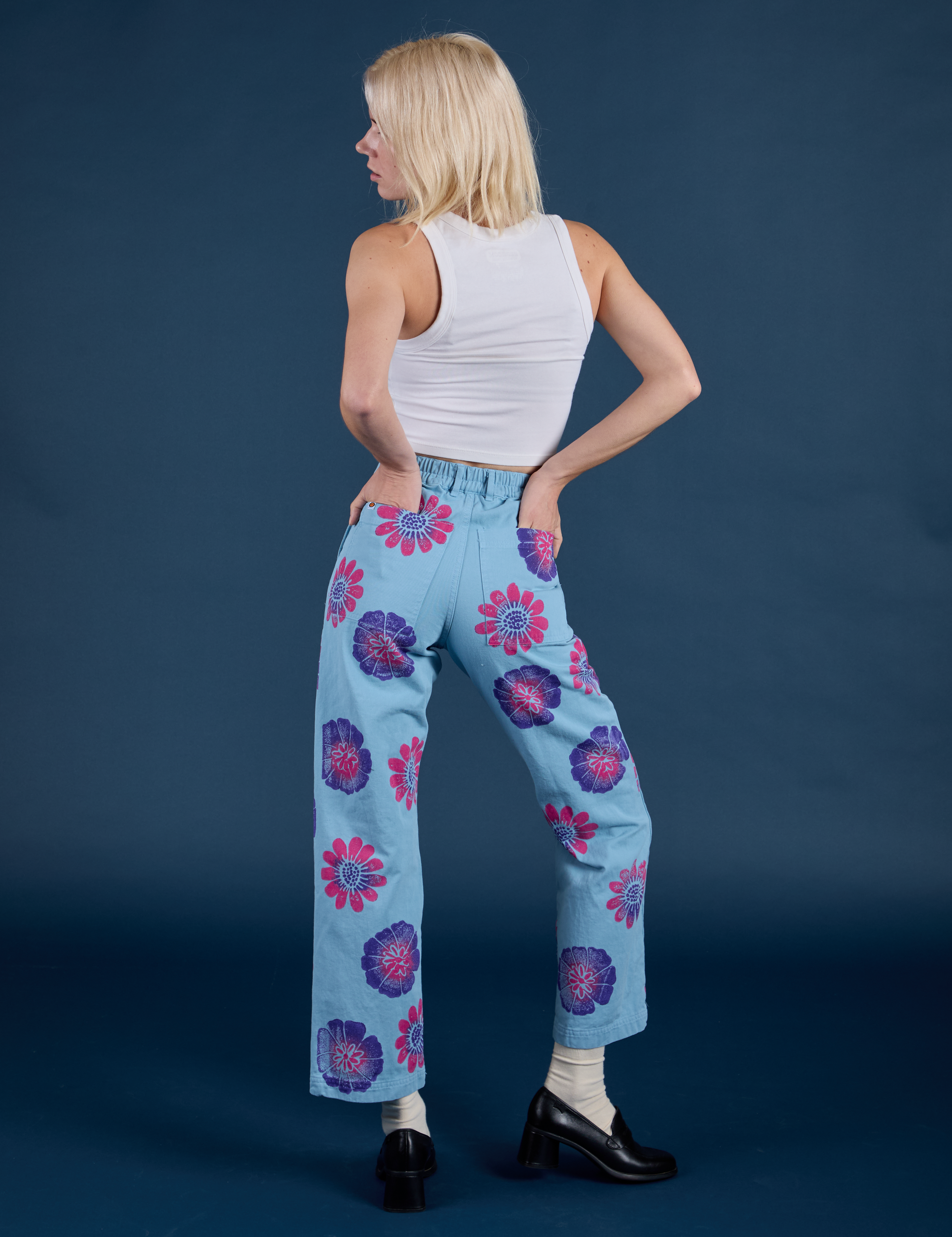 Back view of Floral Painted Work Pants in Blue and Cropped Tank in Vintage Tee white on Madeline