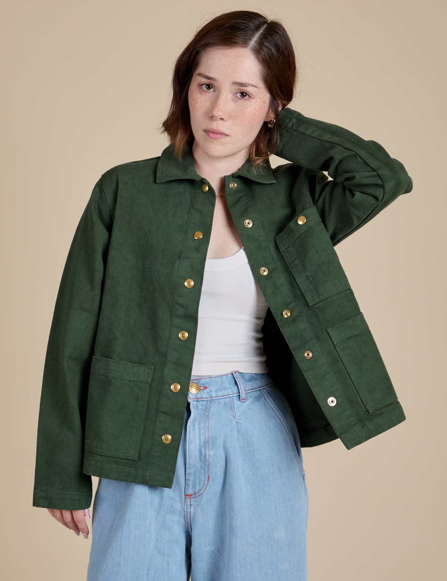 Hana is 5'3" and wearing P Denim Work Jacket in Swamp Green