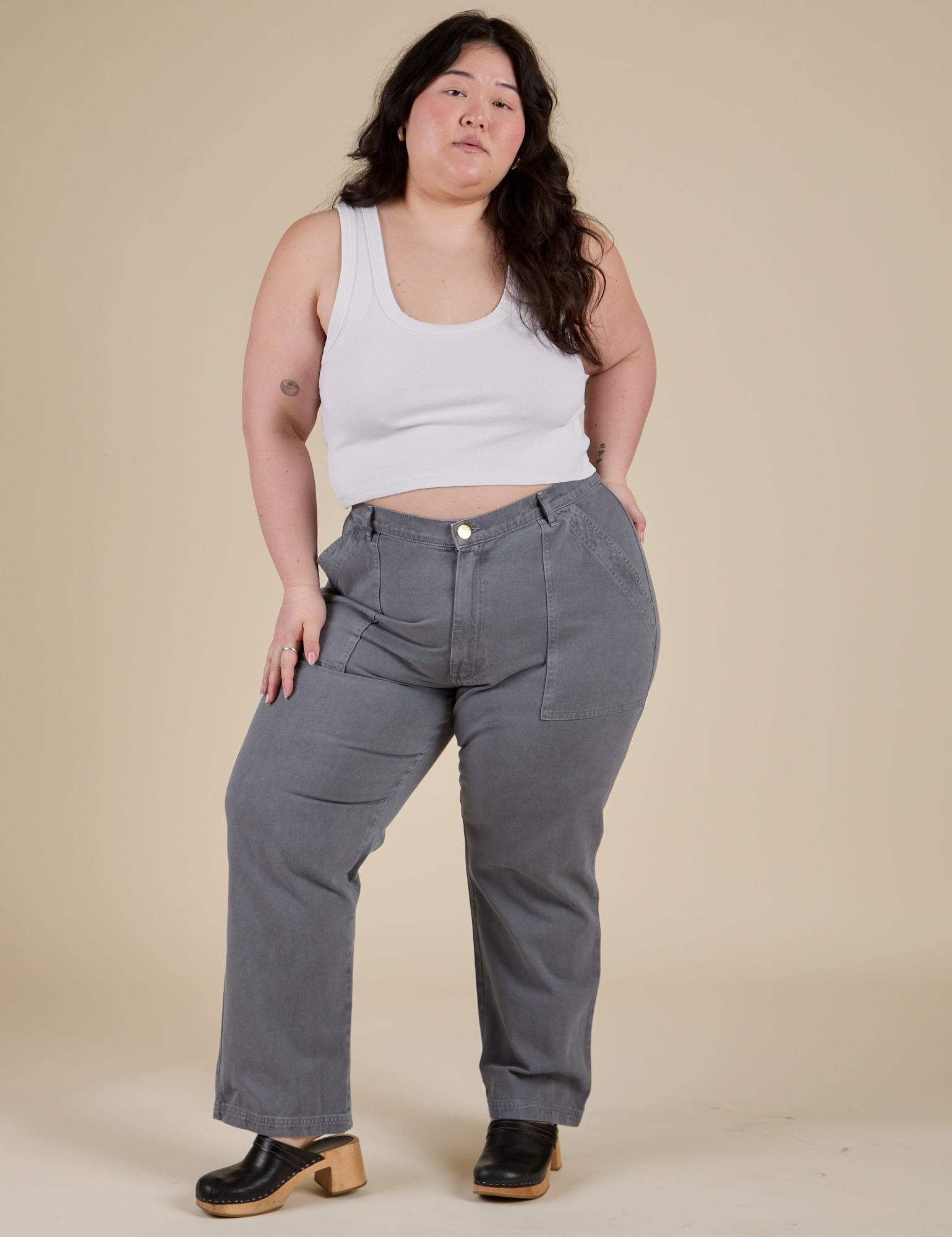 Ashley is wearing Work Pants in Washed Grey and Cropped Tank in Vintage Tee White