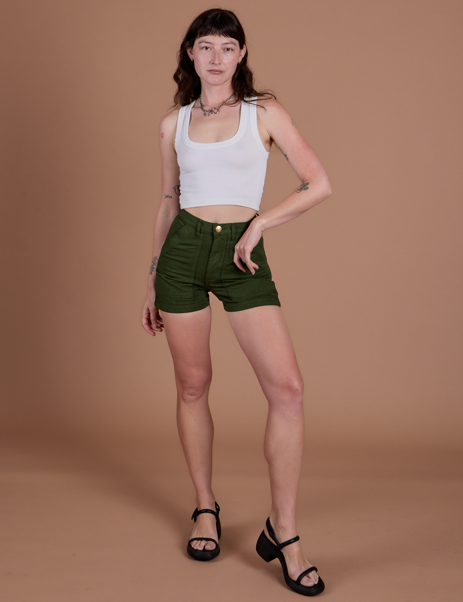 Alex is 5’8” and wearing XXS Classic Work Shorts in Evergreen paired with Cropped Tank in Vintage Tee White