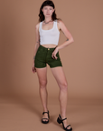 Alex is 5’8” and wearing XXS Classic Work Shorts in Evergreen paired with Cropped Tank in Vintage Tee White