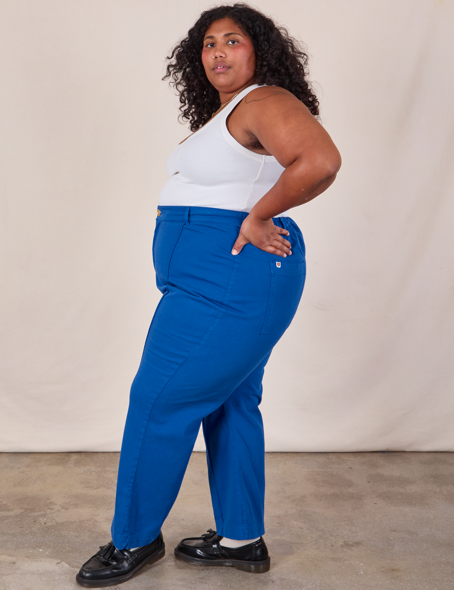 Side view of Western Pants in Royal Blue and Cropped Tank in Vintage Tee Off-White