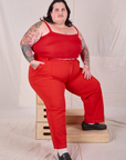 Sam is wearing Mid-Rise Work Pants in Mustang Red and matching Cropped Cami