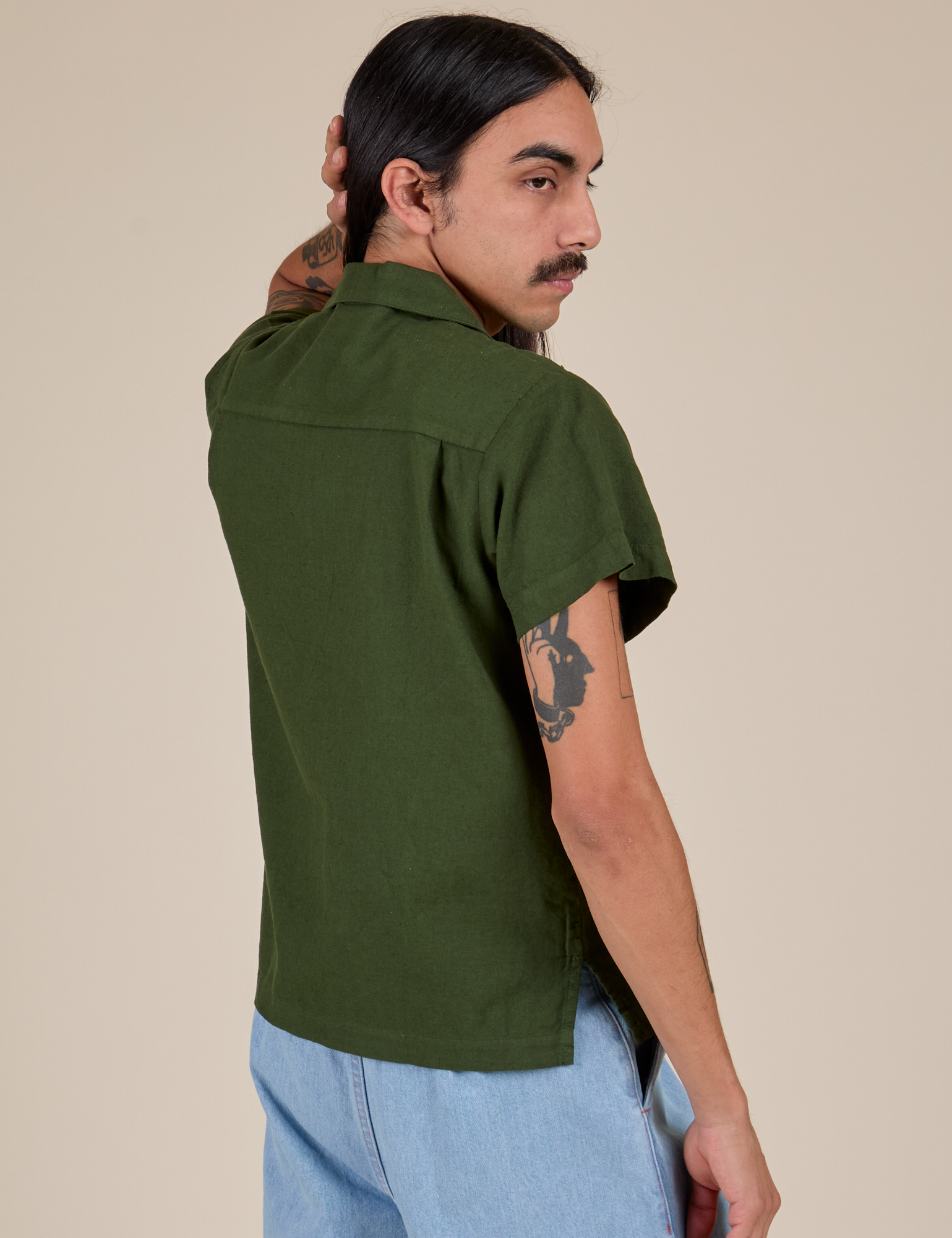 Angled back view of Pantry Button-Up in Evergreen on Anthony