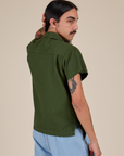Angled back view of Pantry Button-Up in Evergreen on Anthony