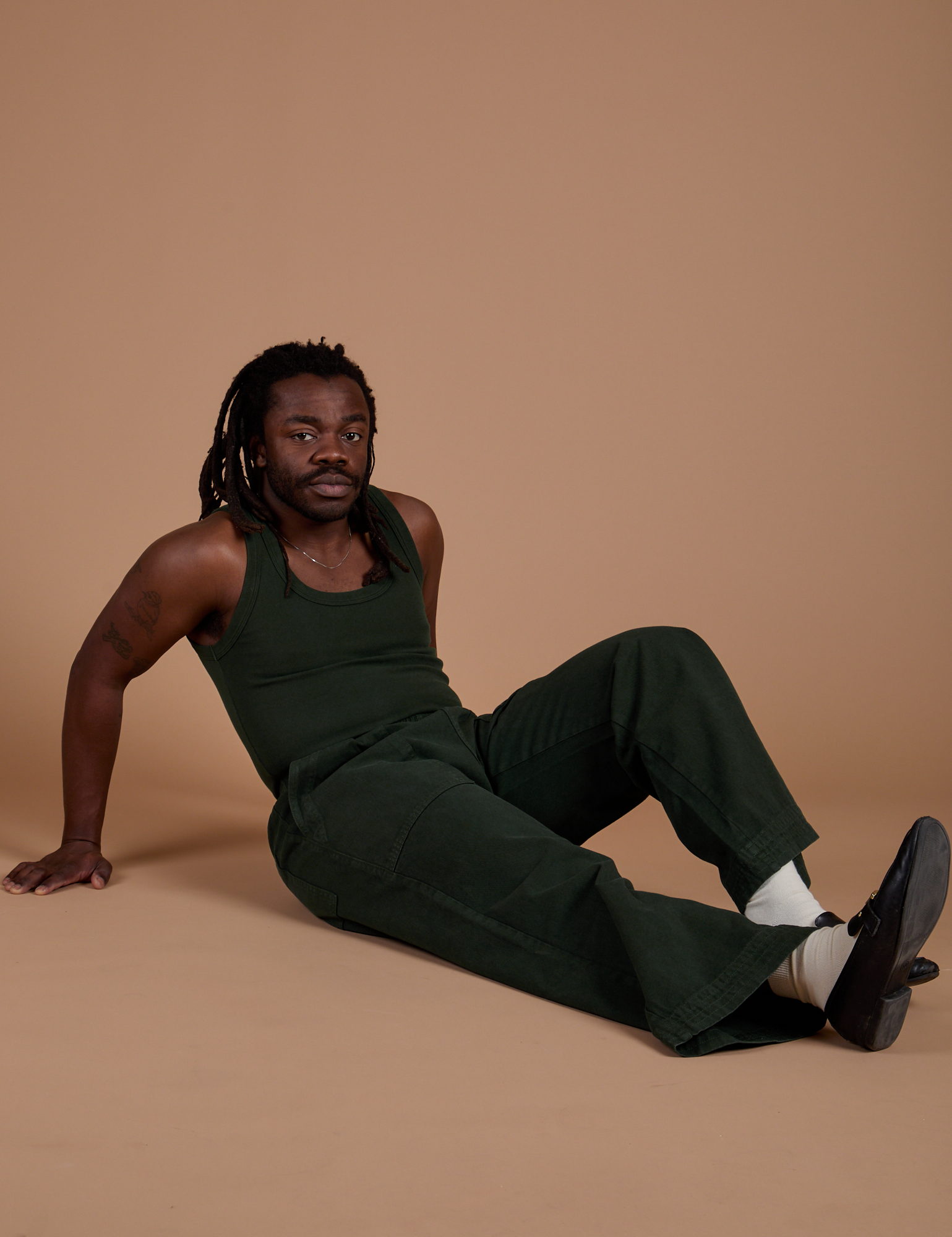 Demi is wearing Action Pants in Swamp Green and Tank Top in Swamp Green