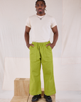 Isaac is 5'10" and wearing M Action Pants in Gross Green paired with Organic Vintage Tee in Vintage Tee Off-White