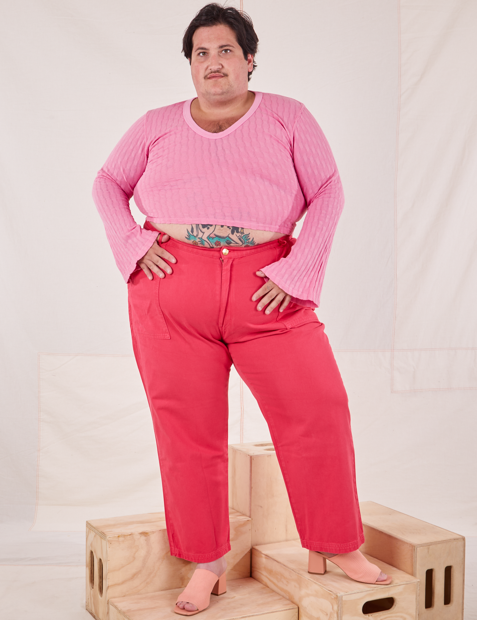 Sam is wearing Bell Sleeve Top in Bubblegum Pink and hot pink Work Pants