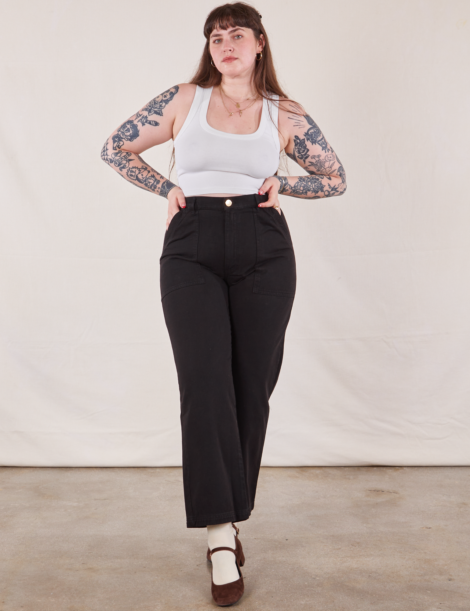 Sydney is 5&#39;9&quot; and wearing M  Work Pants in Black paired with a Cropped Tank in vintage tee off-white