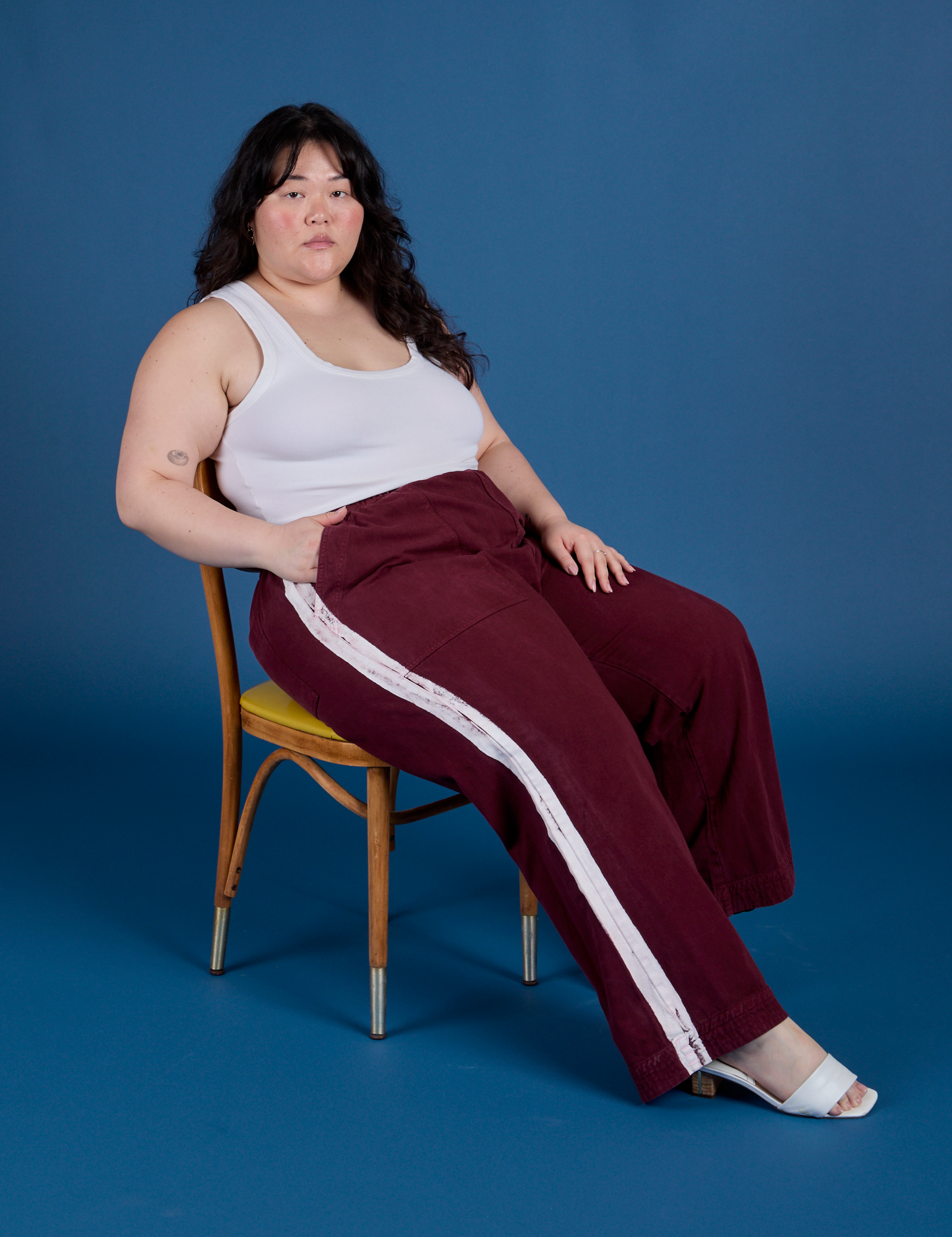 Ashley is wearing Painted Action Pants in Red Wine and Cropped Tank in Vintage Tee White