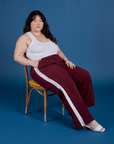 Ashley is wearing Painted Action Pants in Red Wine and Cropped Tank in Vintage Tee White