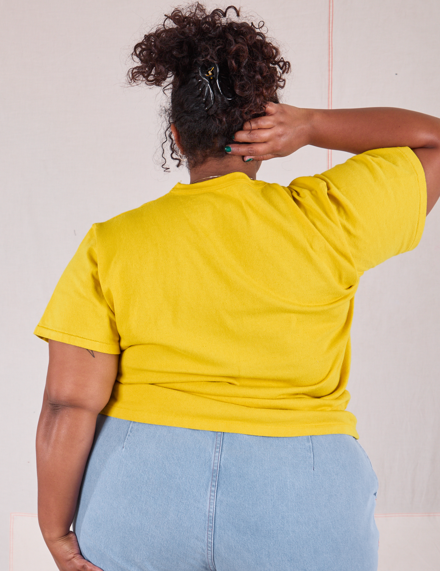 Burly Tee in Golden Yellow back view on Morgan