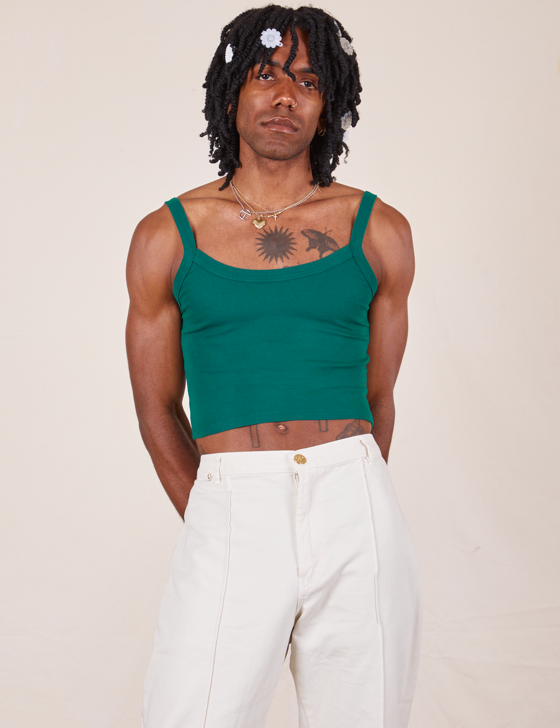Jerrod is wearing Cropped Cami in Hunter Green and vintage off-white Western Pants