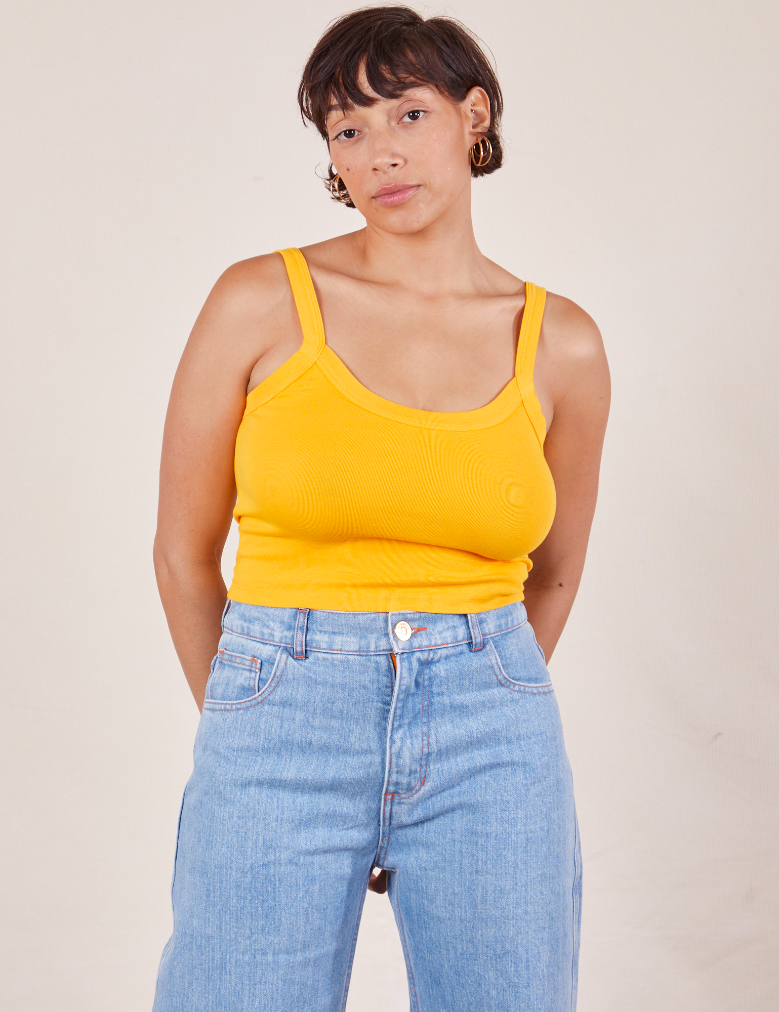 Tiara is 5&#39;4&quot; and wearing XS Cropped Cami in Sunshine Yellow paired with light wash Sailor Jeans