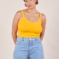 Tiara is 5'4" and wearing XS Cropped Cami in Sunshine Yellow paired with light wash Sailor Jeans