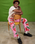 Isaac is wearing Cherry Paintstamped Work Pants in Bubblegum Pink and Organic Vintage Tee in Vintage Off-White