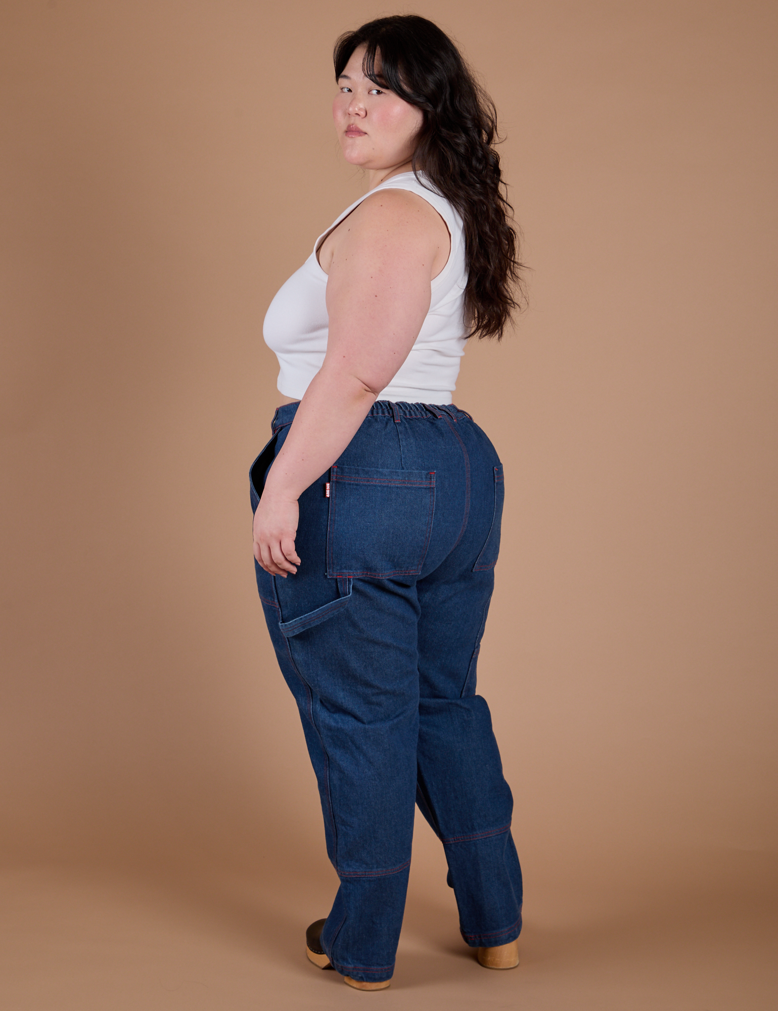 Angled back view of Carpenter Jeans in Dark Wash on Ashley