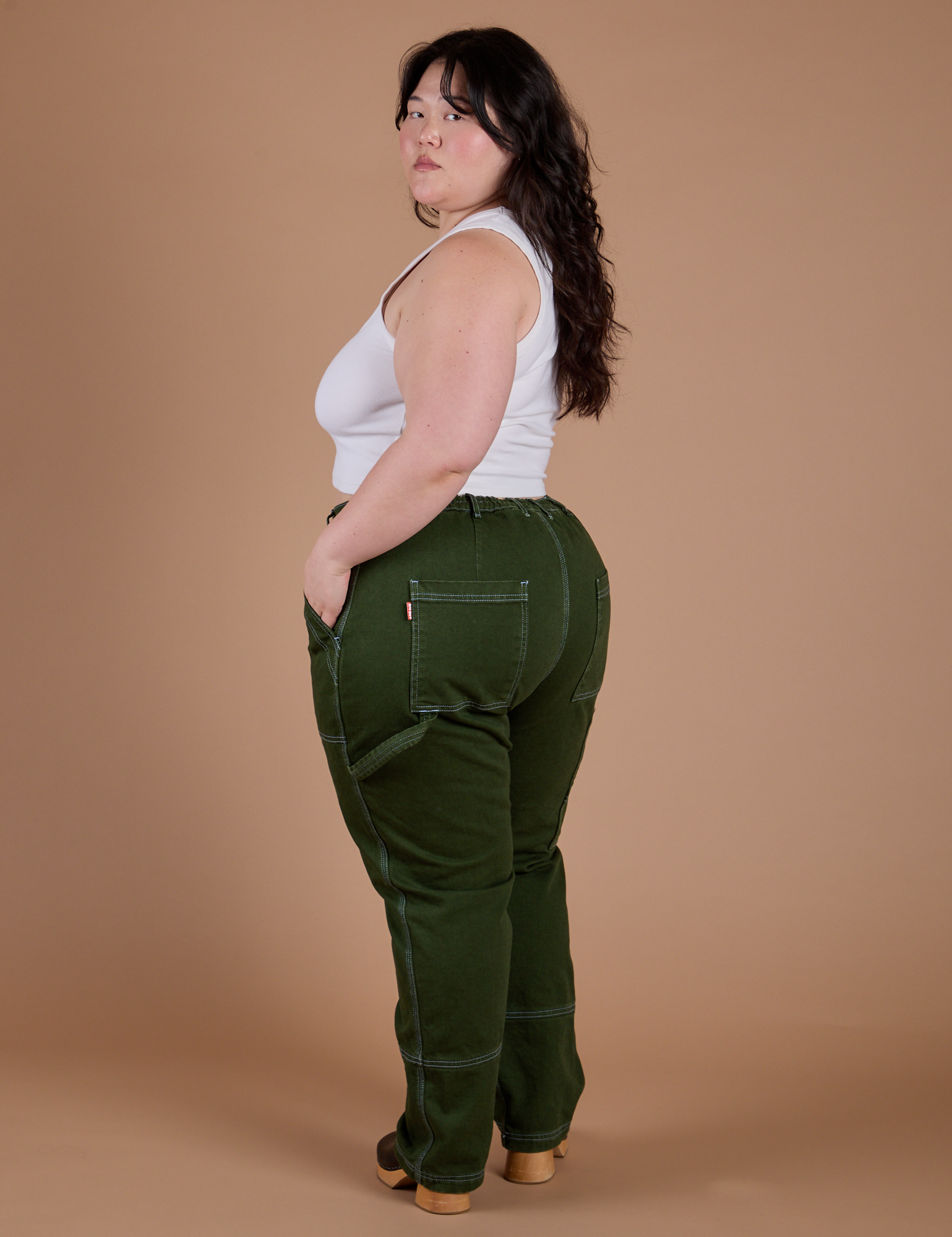 Carpenter Jeans in Evergreen angled back view on Ashley