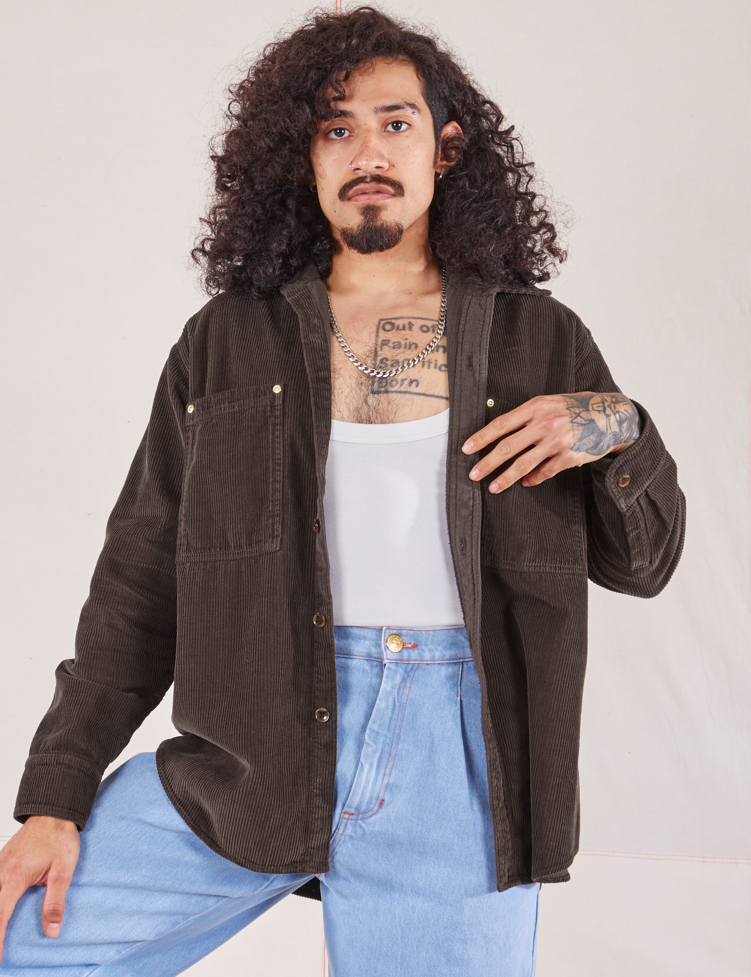 Jesse is 5&#39;8&quot; and wearing XS Corduroy Overshirt in Espresso Brown with a vintage off-white Cropped Tank Top underneath and light wash Denim Trouser Jeans