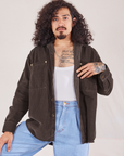 Jesse is 5'8" and wearing XS Corduroy Overshirt in Espresso Brown with a vintage off-white Cropped Tank Top underneath and light wash Denim Trouser Jeans