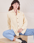 Alex is wearing a buttoned up Corduroy Overshirt in Vintage Off-White and light wash Denim Trouser Jeans