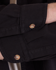 Cropped Overshirt in Basic Black sleeve cuff and tortoise button close up