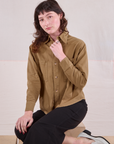 Alex is wearing a buttoned up Cropped Overshirt in Desert Brown