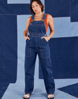 Tiara is 5'4" and wearing XS Indigo Denim Original Overalls in Dark Wash