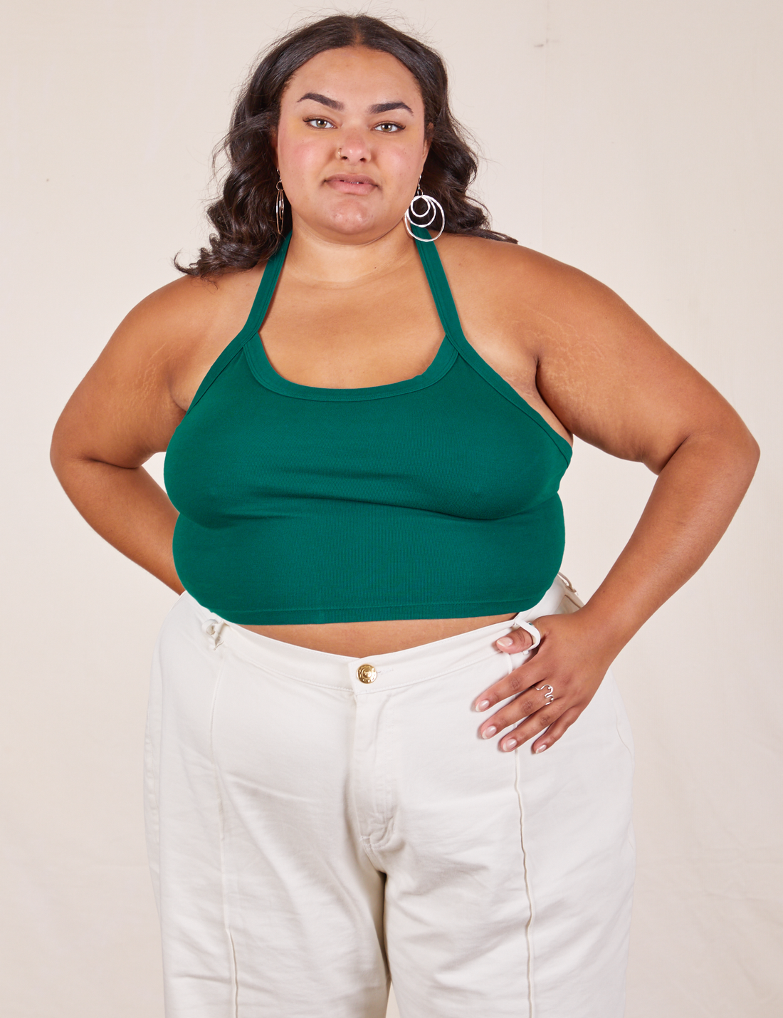 Alicia is 5'9" and wearing XL Halter Top in Hunter Green paired with vintage off-white Western Pants