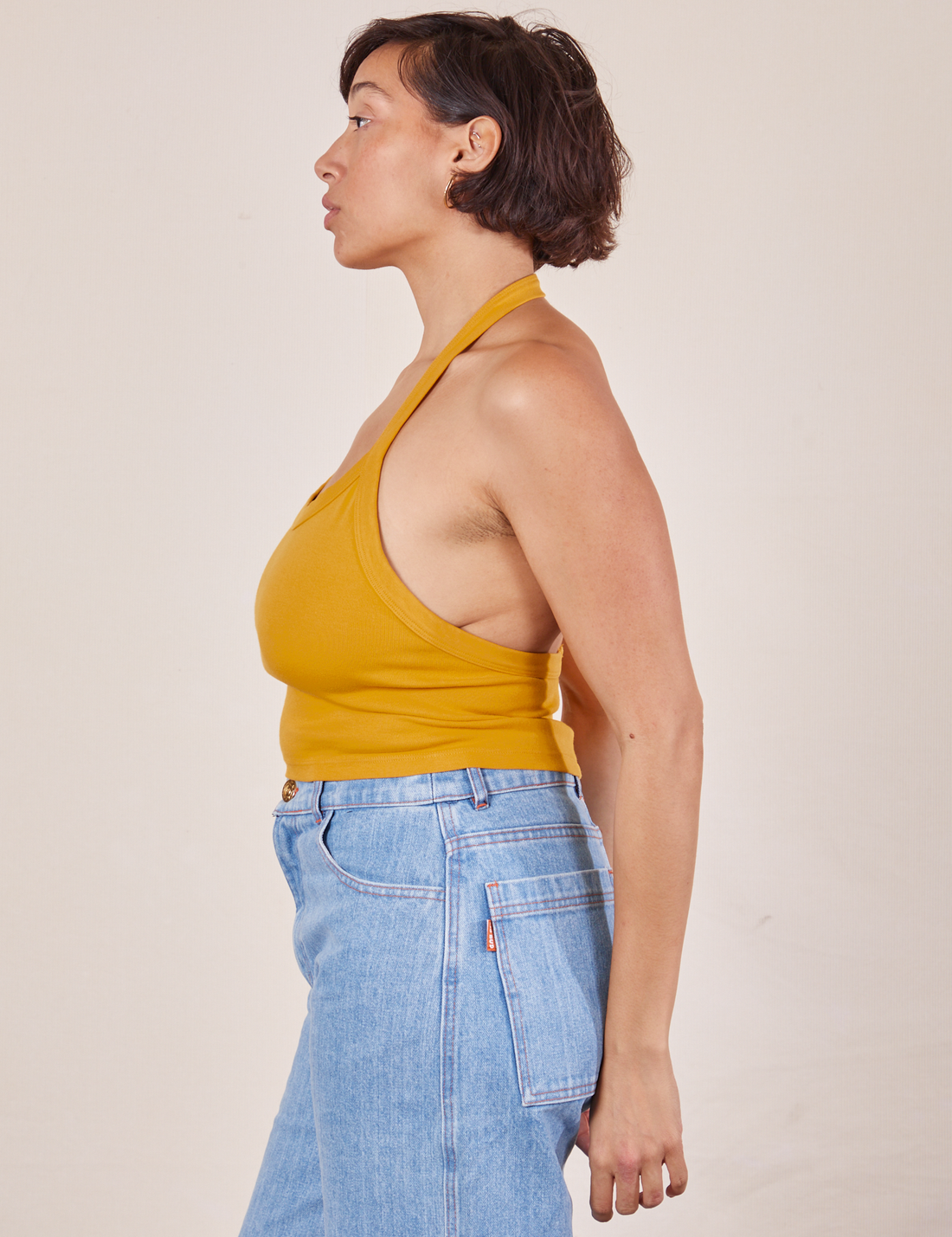 Side view of Halter Top in Mustard Yellow worn by Tiara