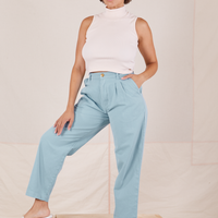 Tiara is 5'4" and wearing S Heavyweight Trousers in Baby Blue paired with vintage off-white Sleeveless Turtleneck