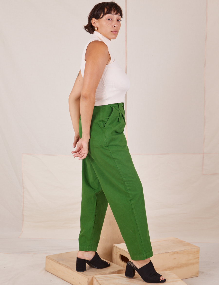 Side view of Heavyweight Trousers in Lawn Green and vintage off-white Sleeveless Turtleneck worn by Tiara