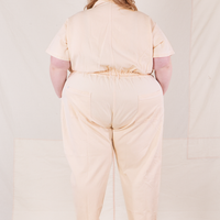 Back view of Heritage Short Sleeve Jumpsuit in Natural worn by Catie