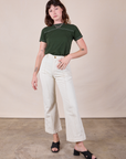 Alex is wearing JV Tee in Swamp Green tucked into vintage tee off-white Western Pants