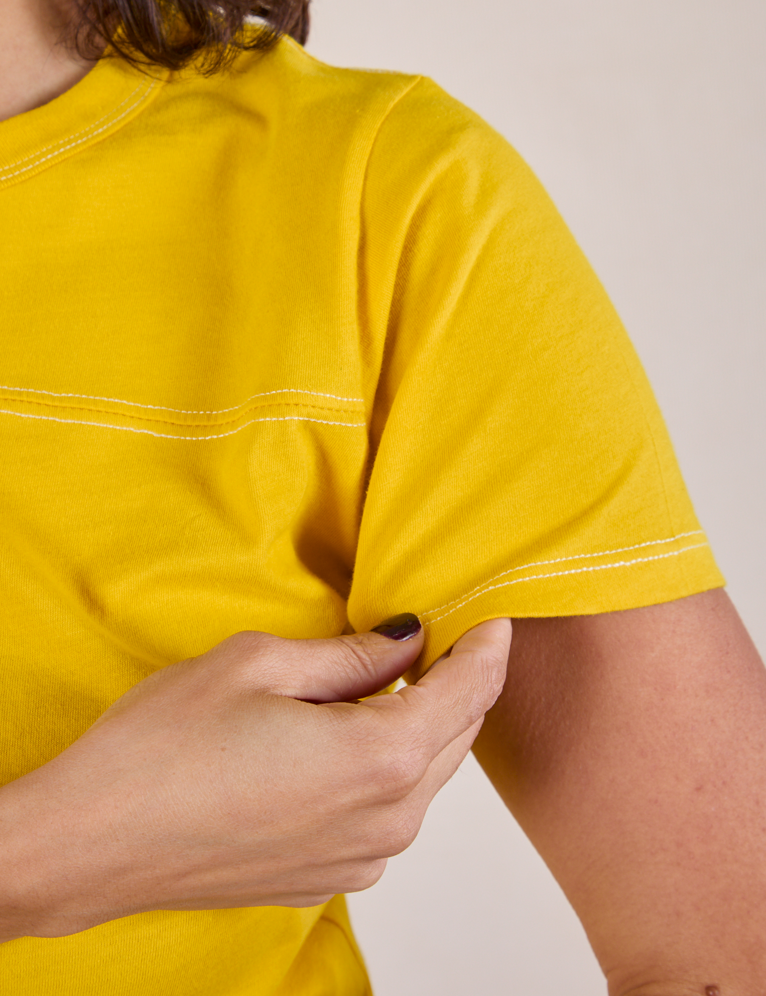 JV Tee in Golden Yellow sleeve close up on Tiara