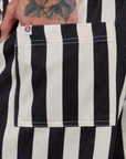 Close up of Jesse's hand in the back pocket of Longline Work Shorts in Natural
