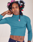 Jerrod is 6'3" and wearing S Essential Turtleneck in Marine Blue