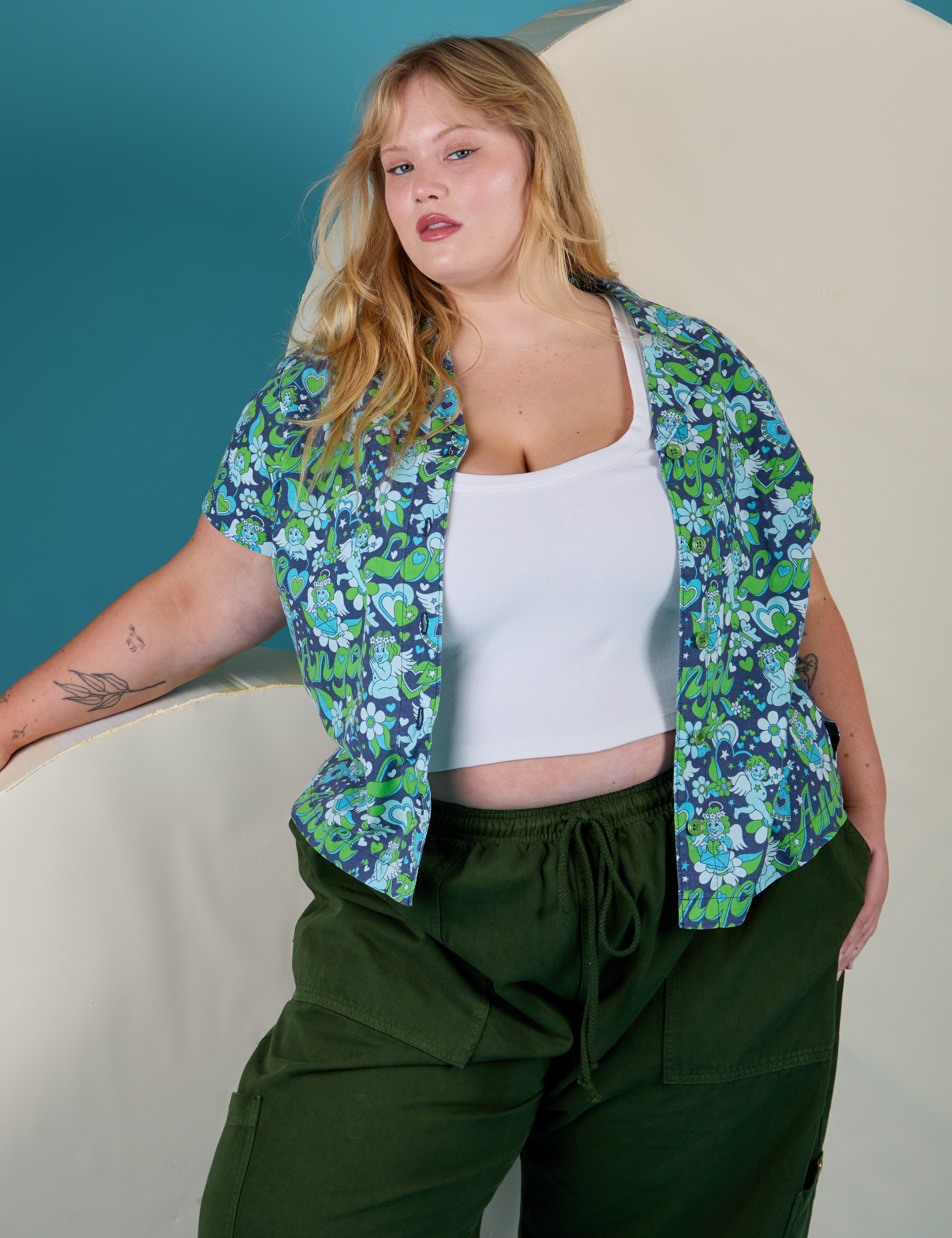 Juliet is wearing Angel Print Pantry Button-Up and evergreen Drop Pocket Cargo Pants