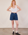 Margaret is 5'11" and wearing XS Denim Trouser Shorts in Dark Wash paired with a Cropped Tank in vintage tee off-white