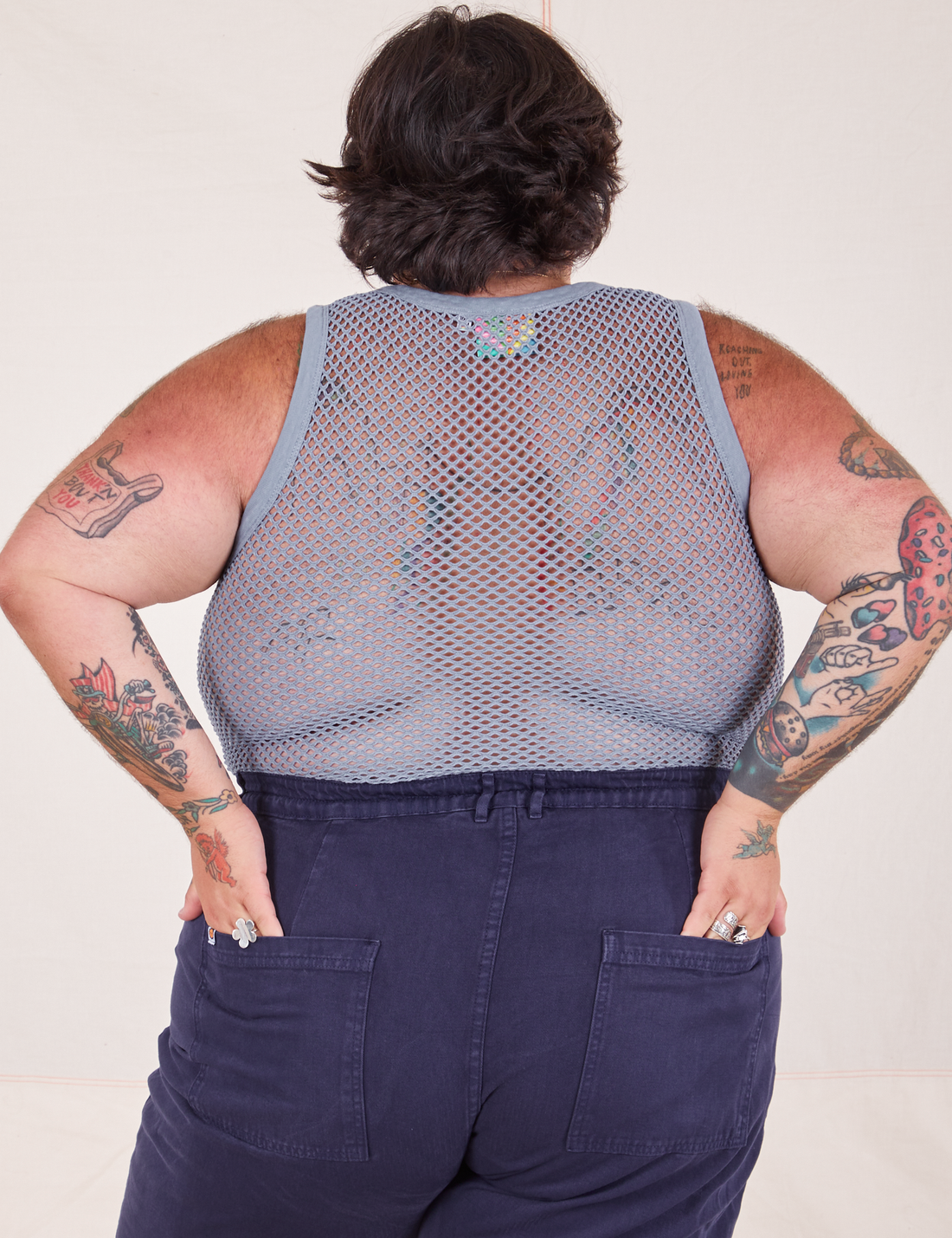 Back view of Mesh Tank Top in Periwinkle and navy Western Pants worn by Sam