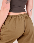 Mid-Rise Pleated Trousers in Desert Brown back close up on Alex